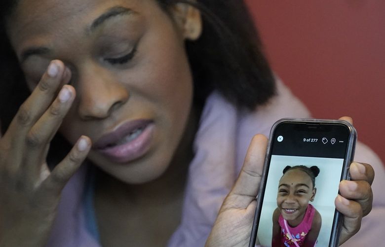 Brittany Tichenor-Cox, holds a photo of her daughter, Isabella “Izzy” Tichenor, during an interview Monday, Nov. 29, 2021, in Draper, Utah. Tichenor-Cox said her 10-year-old daughter died by suicide after she was harassed for being Black and autistic at school. She is speaking out about the school not doing enough to stop the bullying. (AP Photo/Rick Bowmer) UTRB104 UTRB104