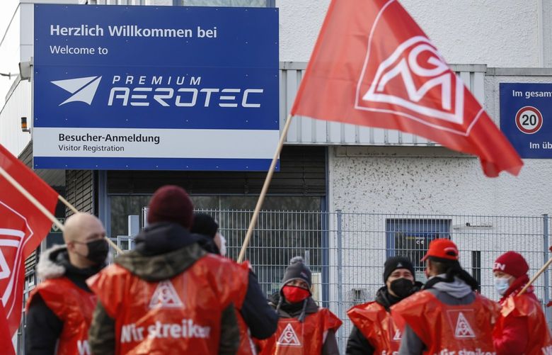 Members of the IG Metall union protest outside the Premium Aerotec GmbH plant, a unit of Airbus SE, during strike action in Augsburg, Germany, on Thursday, Dec. 2, 2021. Airbus SE workers have begun a series of walkouts at German factories, escalating a dispute over the planemaker’s move to restructure aircraft-parts operations in the country. Photographer: Michaela Rehle/Bloomberg