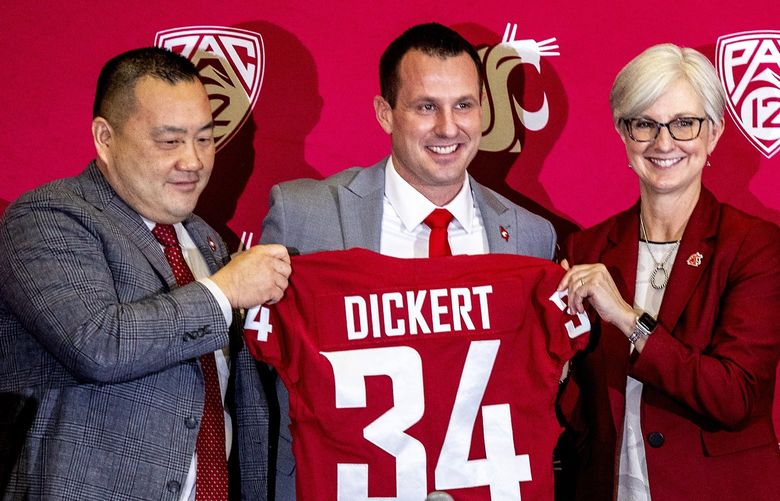 Washington State football coach Jake Dickert stands with Washington State athletic director Pat Chun, left, and Washington State Provost Elizabeth Chilton on Thursday, Dec. 2, 2021, in Pullman, Wash. Dickert was elevated last week from interim coach after the Cougars pounded rival Washington 40-13 in the annual Apple Cup game in Seattle. (August Frank/Lewiston Tribune via AP) IDLEW322 IDLEW322