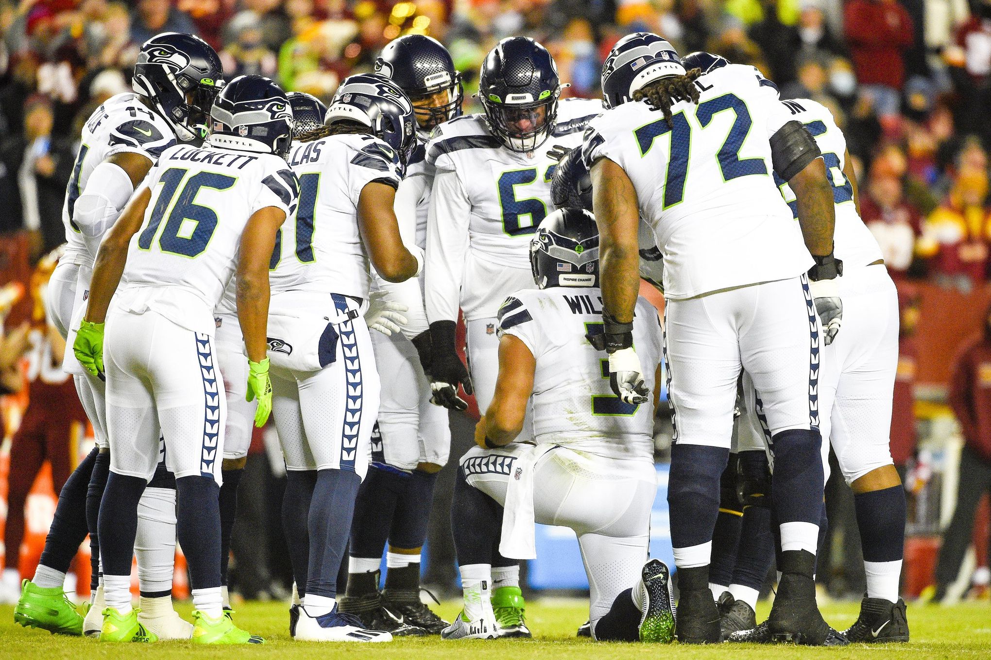 The Seattle Seahawks huddle during an NFL football game against