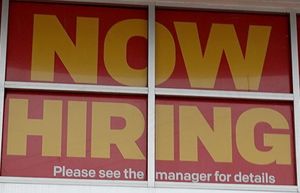 A ”Now Hiring” sign hangs above the entrance to a McDonald’s restaurant on Nov. 5, 2021, in Miami Beach, Florida. (Joe Raedle/Getty Images/TNS) 