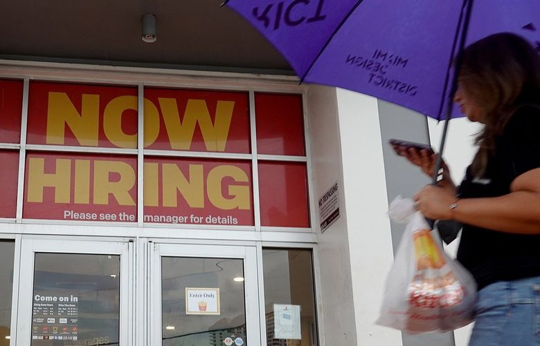A ”Now Hiring” sign hangs above the entrance to a McDonald’s restaurant on Nov. 5, 2021, in Miami Beach, Florida. (Joe Raedle/Getty Images/TNS) 33785776W 33785776W