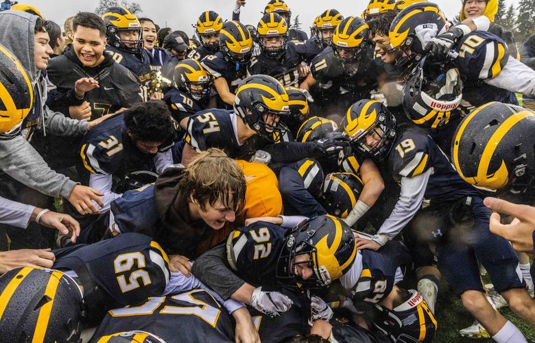 Bellevue High School celebrates their win against Kennewick High School during the WIAA mens football championship at Sparks Stadium in Puyallup on Saturday, Dec. 4, 2021.  218928