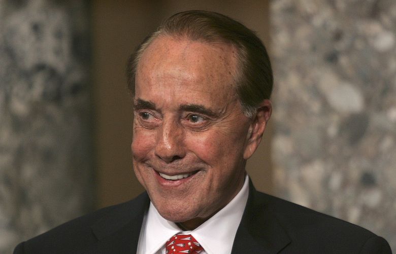 FILE – Former Senate Majority Leader Bob Dole, R-Kan., attends the unveiling of his portrait at the U.S. Capitol, in Washington, July 25, 2006. Bob Dole, who overcame disabling war wounds to become a sharp-tongued Senate leader from Kansas, a Republican presidential candidate and then a symbol and celebrant of his dwindling generation of World War II veterans, has died. He was 98. 
His wife, Elizabeth Dole, posted the announcement Sunday, Dec. 5, 2021, on Twitter. (AP Photo/Lawrence Jackson, File) NY165 NY165