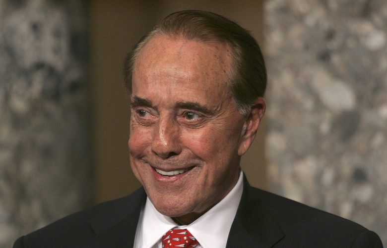 FILE – Former Senate Majority Leader Bob Dole, R-Kan., attends the unveiling of his portrait at the U.S. Capitol, in Washington, July 25, 2006. Bob Dole, who overcame disabling war wounds to become a sharp-tongued Senate leader from Kansas, a Republican presidential candidate and then a symbol and celebrant of his dwindling generation of World War II veterans, has died. He was 98.
His wife, Elizabeth Dole, posted the announcement Sunday, Dec. 5, 2021, on Twitter. (AP Photo/Lawrence Jackson, File) NY165 NY165