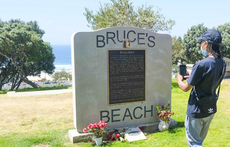 FILE – This April 8, 2021 file photo, shows a monument at Bruce’s Beach in Manhattan Beach, Calif. Gov. Gavin Newsom was expected to sign legislation Thursday, Sept. 30, 2021, to enable the transfer of ownership of prime Southern California beachfront property to heirs of a Black couple who built a small resort for Black people in the early 1900s but were harassed and finally stripped of the land by local city leaders.  (Dean Musgrove/The Orange County Register via AP, File) CAANR403