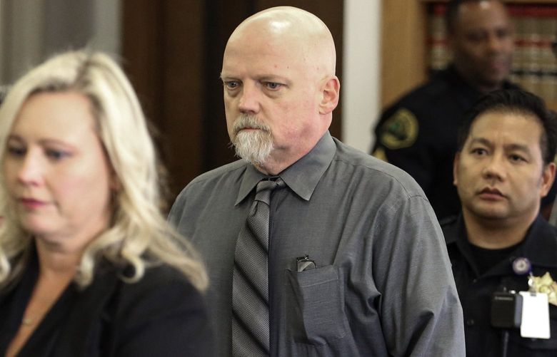 William Talbott II, center, in escorted to his seat Friday June 28, 2019 at the Snohomish County Courthouse in Everett, Wash. William Earl Talbott II has been found guilty in the 1987 killings of a young Canadian couple. (Kevin Clark/The Herald via AP) WAEVE104 WAEVE104 WAEVE104
