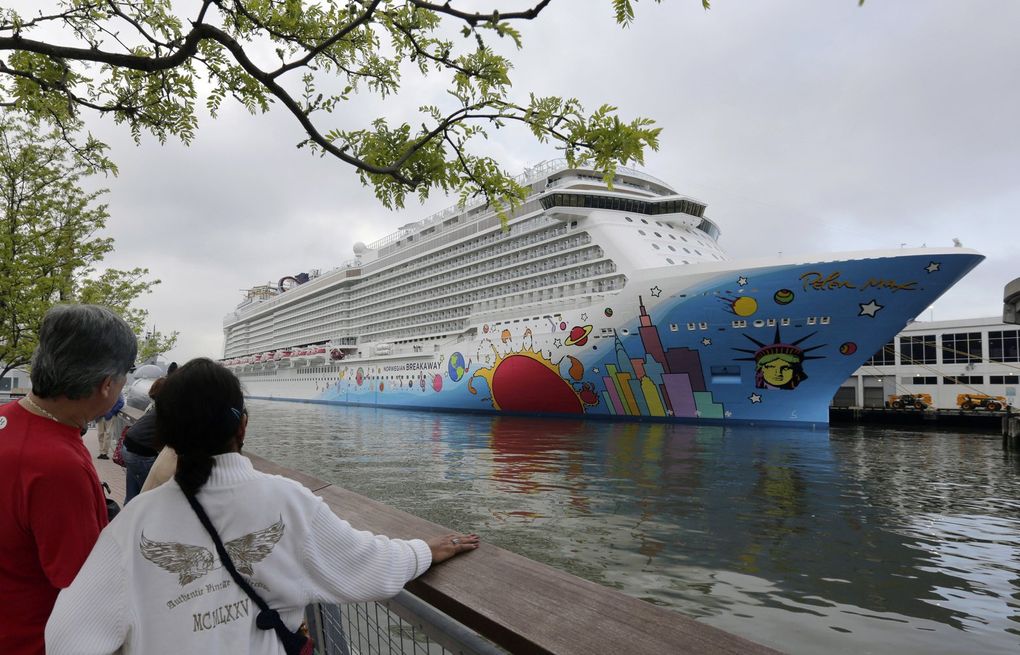 FILE – People pause to look at Norwegian Cruise Line’s ship, Norwegian Breakaway, on the Hudson River, in New York, on May 8, 2013. Ten people aboard the cruise ship, approaching New Orleans, have tested positive for COVID-19, officials said Saturday night, Dec. 4, 2021. The Norwegian Breakaway had departed New Orleans on Nov. 28 and is due to return this weekend, the Louisiana Department of Health said in a news release. Over the past week, the ship made stops in Belize, Honduras and Mexico. (AP Photo/Richard Drew, File)