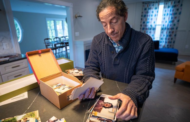 Jamie Raskin sifts through family photos at home. MUST CREDIT: Photo for The Washington Post by André Chung