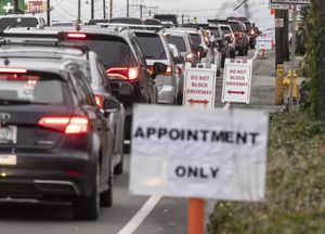 Cars stretch for blocks on Aurora Avenue North in Seattle as people wait to be tested for the coronavirus. (Steve Ringman / The Seattle Times)