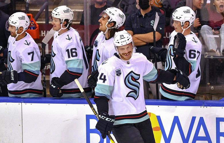Seattle Kraken defenseman Jamie Oleksiak (24) celebrates an empty-net goal against the Florida Panthers during the third period of an NHL hockey game Saturday, Nov. 27, 2021, in Sunrise, Fla. (AP Photo/Jim Rassol) FLJS112 FLJS112