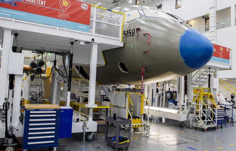 An Airbus A220 plane at the Airbus Canada LP assembly and finishing site in Mirabel, Quebec, Canada, on Wednesday, Nov. 17, 2021. Air Lease Corp. is seeing demand for single-aisle jets like Airbus SE’s A320neo and A220 families outstrip the planemakers’ current rates of manufacturing. Photographer: Graham Hughes/Bloomberg