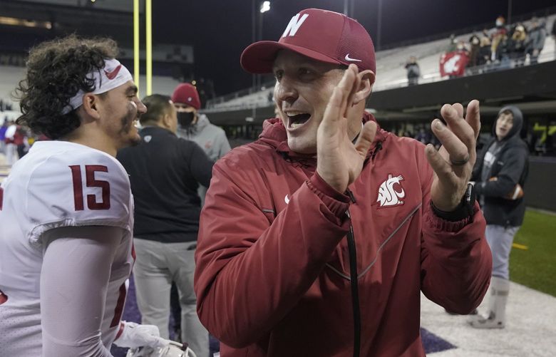 Washington State head coach Jake Dickert, right, celebrates with wide receiver Mitchell Quinn (15) after WSU beat Washington 40-13 in an NCAA college football game, Friday, Nov. 26, 2021, in Seattle. (AP Photo/Ted S. Warren) OTK OTK