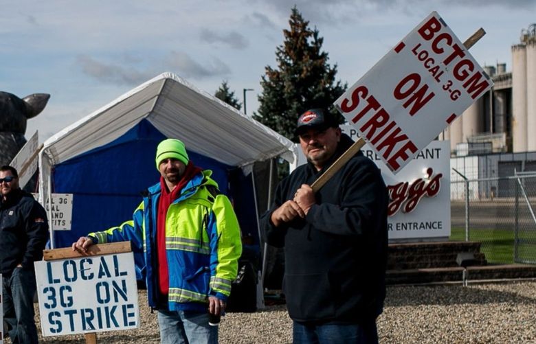 Demonstrators hold signs during a union workers strike outside the Kellogg plant in Battle Creek, Michigan, U.S., on Friday, Oct. 22, 2021. MUST CREDIT: Bloomberg photo by Jenifer Veloso