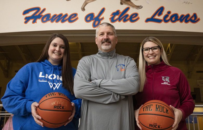 Auburn Mountainview High School athletic director Chris Carr, with his daughters Cait, left, and Aly, right, Wednesday, Dec. 8, 2021 in Auburn. The daughters played basketball for their dad when he was coach here and are now both in their first year running their own programs.  218999