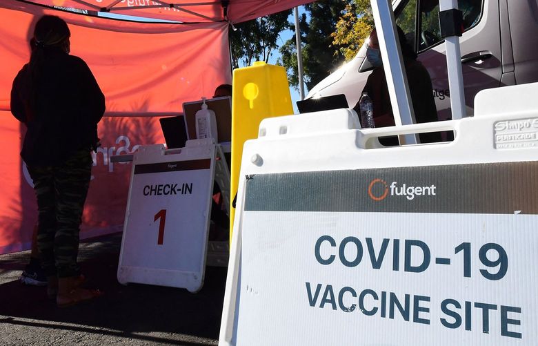 People check-in for their COVID-19 vaccine at a pop-up clinic offering vaccines and booster shots in Rosemead, California, on Monday, Nov. 29, 2021. (Frederic J. Brown/AFP/Getty Images/TNS) 34121961W 34121961W