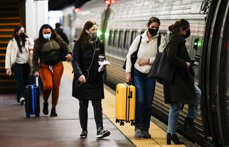 Travelers board an Amtrak train ahead of the Thanksgiving Day holiday at 30th Street Station in Philadelphia, Wednesday, Nov. 24, 2021. (AP Photo/Matt Rourke) PAMR113 PAMR113
