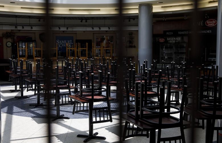 Chairs rest on tables in a food court at O’Hare International Airport in Chicago on June 13, 2020. MUST CREDIT: Bloomberg photo by Patrick T. Fallon
