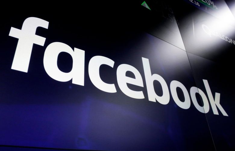FILE – This March 29, 2018, file photo shows the Facebook logo on screens at the Nasdaq MarketSite, in New York’s Times Square. Facebook’s parent company Meta announced Wednesday, Dec. 8, 2021, that it has expanded its ban on postings linked to Myanmar’s military to include all pages, groups, and accounts representing military-controlled businesses. It had already banned advertising from such businesses in February. (AP Photo/Richard Drew, File)