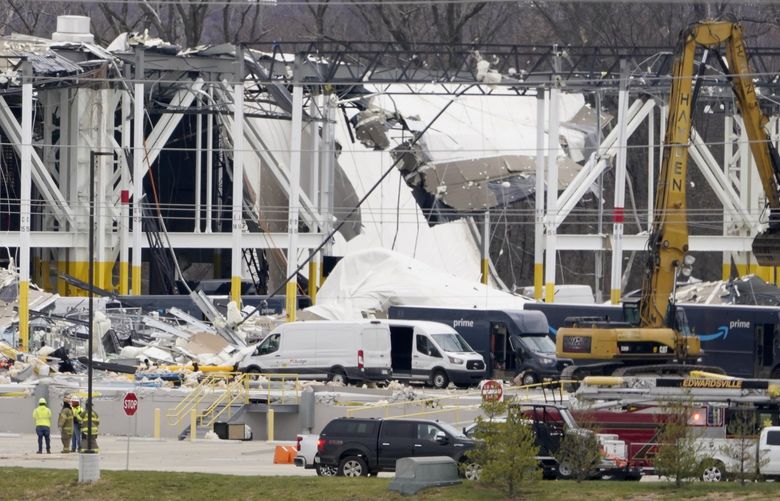 A heavily damaged Amazon fulfillment center is seen Saturday, Dec. 11, 2021, in Edwardsville, Ill. A large section of the roof of the building was ripped off and walls collapsed when strong storms moved through area Friday night. (AP Photo/Jeff Roberson) ILJR108 ILJR108
