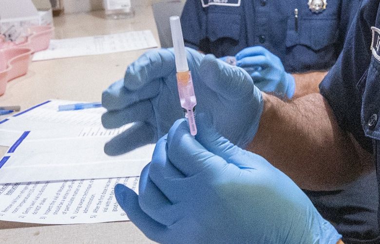 Lt. Jeremiah Ingersoll (r) with the Northshore Fire Department draws the moderna vaccine for COVID-19 as Nate Bess (in background) with the Shoreline Fire Department assembles syringes at the Shoreline Center in Shoreline Tuesday, April 27, 2021 in preparation for people coming in for their COVID-19 vaccines.  500 shots will be given on the first day, April 27, 2021 and after that 1,000 will be given daily.


UW Medicine is opening a new North King County COVID-19 vaccination site in Shoreline at the Shoreline Center to expand access to the vaccine for residents of North King County. The site is being operated in partnership with the Shoreline, Northshore, and Bothell fire departments. The King County Vaccination Partnership â€“ Shoreline joins a network of vaccination partner sites in Auburn, Kent, Redmond, Renton, and Seattle. 

Washington men are lagging behind women on vaccinations in the state, following national trends.