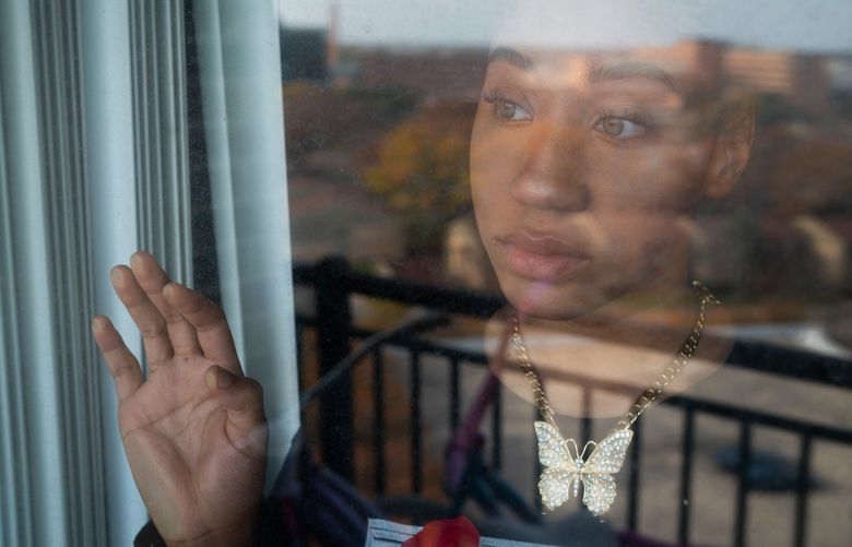 Samara Duplessis looks through a window on a November morning at her mother’s apartment outside Detroit. MUST CREDIT: Washington Post photo by Sarah L. Voisin