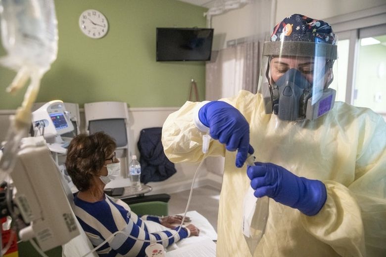 Registered nurse Alexandria Kilby hooks up a monoclonal antibody infusion to Donna Hipsher in St. Luke’s Emergency Department in Duluth, Minn., earlier this year. (Alex Kormann / Star Tribune)
