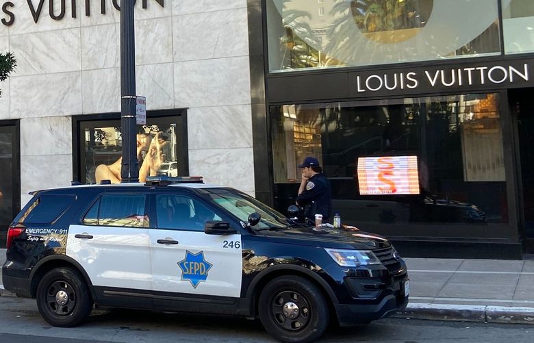FILE – Police officers and emergency crews park outside the Louis Vuitton store in San Francisco’s Union Square on Nov. 21, 2021, after looters ransacked businesses. Stung by recent headline-grabbing smash-and-grab robberies at high-end stores, California Gov. Gavin Newsom said Friday, Dec. 17, 2021, that he will seek more than $300 million over three years to boost law enforcement efforts on retail theft, while he also is targeting increasing gun violence. (Danielle Echeverria/San Francisco Chronicle via AP, File) CAFRA501 CAFRA501
