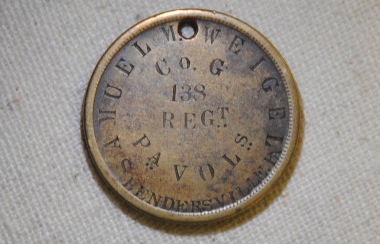The back of a small, bronze-colored identification disk belonging to Samuel M. Weigel, a private with Company G of the 138th Pennsylvania Infantry. According to regimental history, Weigel was severely wounded during the Battle of Monocacy but survived. MUST CREDIT: National Park Service.