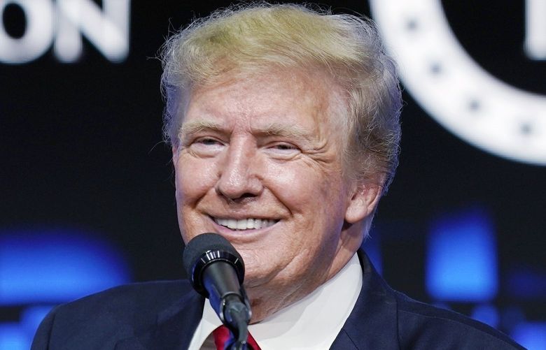 FILE – Former President Donald Trump smiles as he pauses while speaking to supporters at a Turning Point Action gathering in Phoenix, July 24, 2021. Trump has revealed he received a booster shot of the COVID-19 vaccine, drawing boos from a crowd in Dallas. Trump made the disclosure Sunday night during the final stop of â€œThe History Tour,â€ a live interview show he has been doing with former Fox News host Bill Oâ€™Reilly. (AP Photo/Ross D. Franklin, File) NYPS208 NYPS208