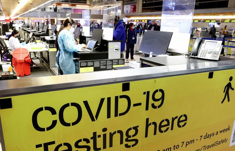 A COVID-19 test center operates inside the Tom Bradley International Terminal at Los Angeles International Airport on Dec. 1, 2021, in Los Angeles. The CDC now has started distributing free COVID-19 home test kits to international travelers arriving at airports in America. (Mario Tama/Getty Images/TNS) 35308742W 35308742W