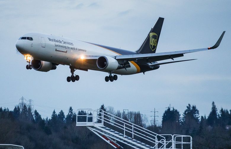 A Boeing 767 arrives at Boeing Field ferrying parcels for UPS. Amazon is considering venturing into the same territory as UPS and FedEx, acquiring similar freighters for its own air cargo service.
