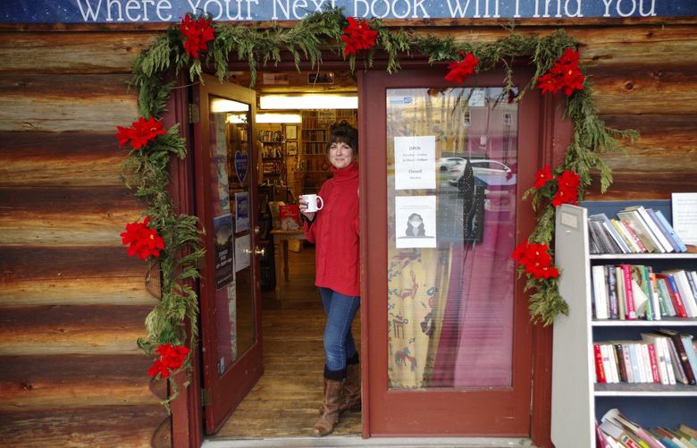 Co-owner Leah McNatt stands in the doorway at magical Uppercase Bookshop in Snohomish, which is Seattle’s only independent bookstore nestled in a log cabin.