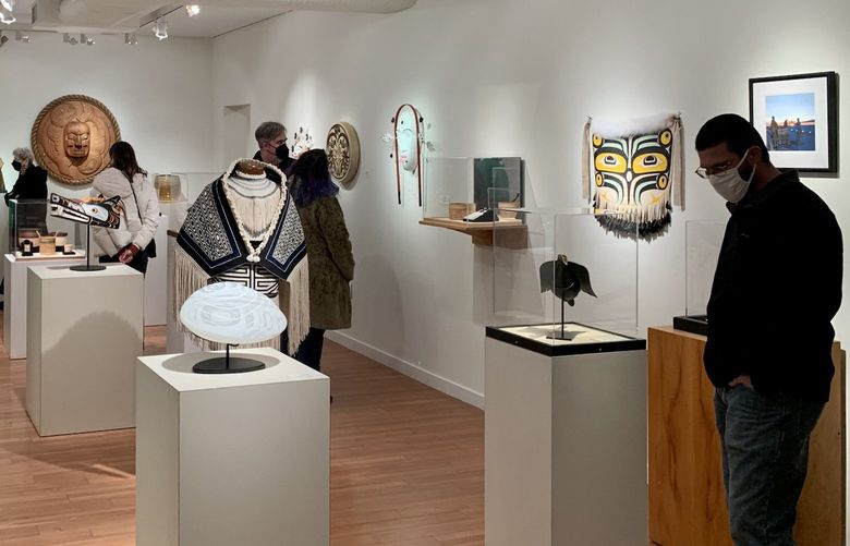 Attendees observe new artworks at Stonington Gallery during Pioneer Square’s First Thursday Art Walk. The gallery’s “RECONNECTION: Celebrating Coming Together” group exhibition is on display through Jan. 29.