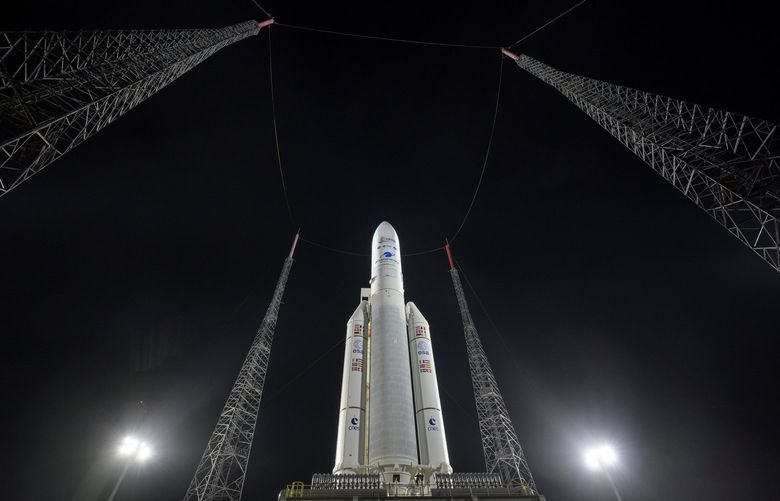 In this photo provided by NASA, Arianespace’s Ariane 5 rocket with NASA’s James Webb Space Telescope onboard, is seen at the launch pad, Thursday, Dec. 23, 2021, at Europe’s Spaceport, the Guiana Space Center in Kourou, French Guiana. The James Webb Space Telescope has infrared vision, allowing it to peer deeper into the universe, all the way to the first stars and galaxies. Liftoff is set for Saturday morning, Dec. 24, on a French rocket from South America. (Bill Ingalls/NASA via AP) NYPH501 NYPH501