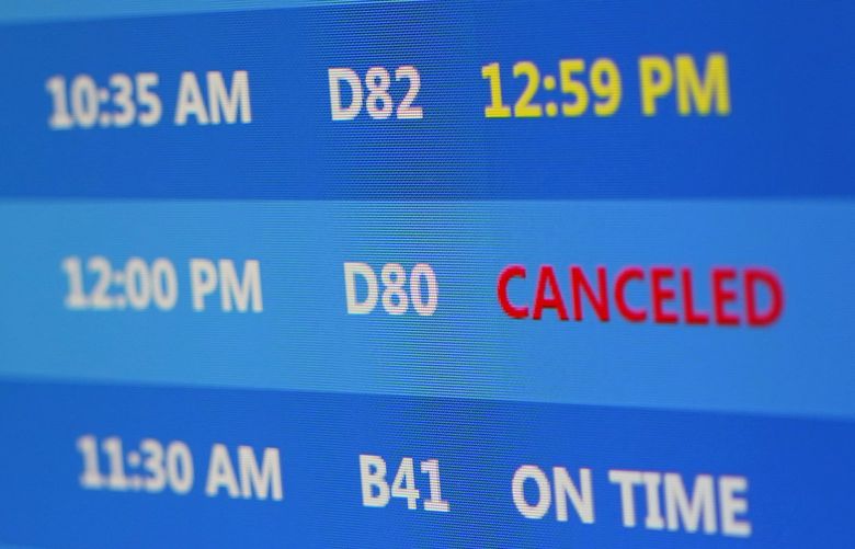A canceled Delta flight is listed on the departures at at Pittsburgh International Airport in Imperial, Pa., Monday, Dec. 27, 2021. (AP Photo/Gene J. Puskar) PAGP103 PAGP103