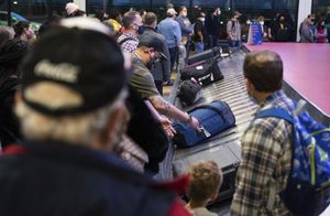 12 月 27 日星期一，人们在宾夕法尼亚州芬德利镇的匹兹堡国际机场的行李领取区寻找行李。由于天气和与冠状病毒相关的人员短缺引发的航班中断在周二似乎略有缓解，但仍达超过 800 次取消，使全国各地的度假旅客陷入困境，许多人试图返回家园。 （艾米丽马修斯/匹兹堡邮报通过美联社）