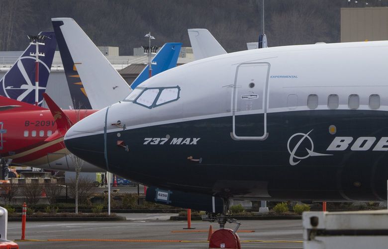 Boeing 737 MAX planes are grounded on the west side of Marginal Way, across from Boeing Field in Seattle, shot Friday, December 17, 2021. 219100