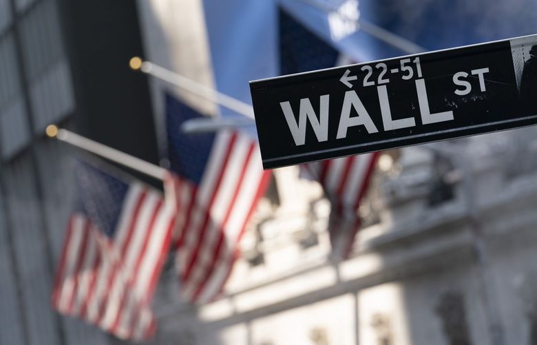 FILE – A sign for Wall Street hangs in front of the New York Stock Exchange, July 8, 2021.  (AP Photo/Mark Lennihan, file) 