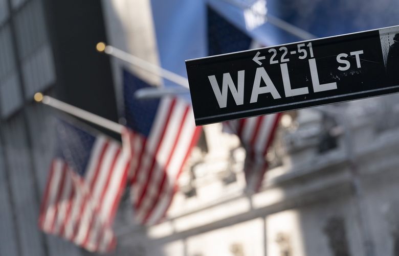 FILE – A sign for Wall Street hangs in front of the New York Stock Exchange, July 8, 2021. (AP Photo/Mark Lennihan, file)