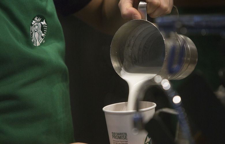 A barista pours a drink inside a Starbucks coffee shop. (Victor J. Blue/Bloomberg)