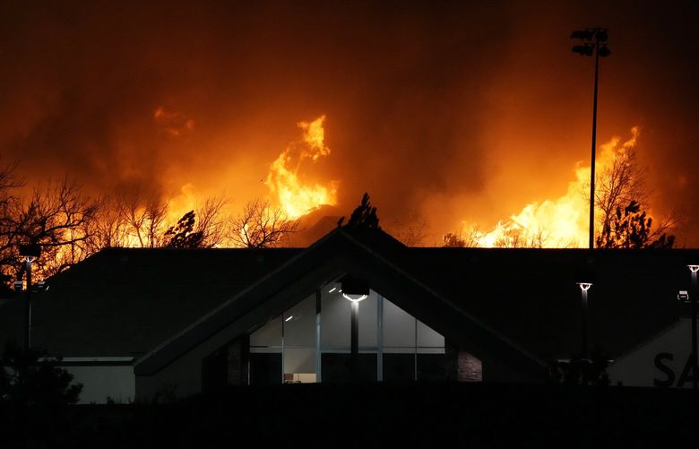 Flames explode as wildfires burned near a small shopping center Thursday, Dec. 30, 2021, near Broomfield, Colo. Homes surrounding the Flatiron Crossing mall were being evacuated as wildfires raced through the grasslands as high winds raked the intermountain West. (AP Photo/David Zalubowski) CODZ127 CODZ127