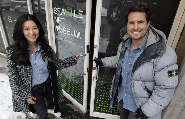 Jennifer Wong and Peter Hamilton, founders of the Seattle NFT Museum, are seen outside a new museum dedicated to non-fungible-token digital art, and the NFT community, Tuesday, Dec. 28, 2021 in downtown Seattle. Doors will open to the public January 14. 219173