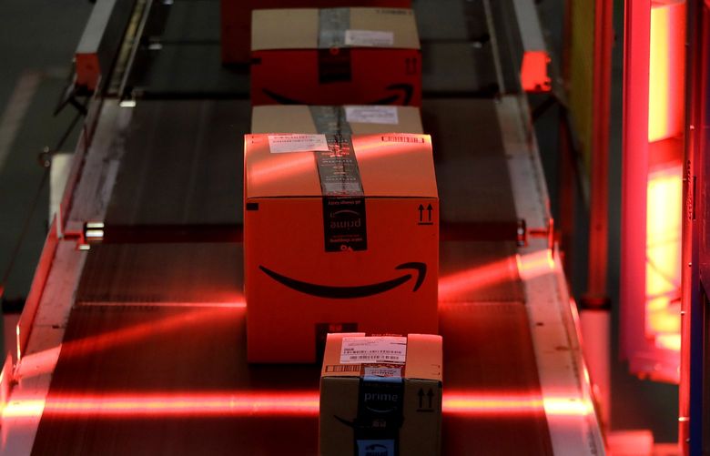 Packages riding on a belt are scanned to be loaded onto delivery trucks at the Amazon Fulfillment center in Robbinsville Township, New Jersey, in 2017. (Julio Cortez / The Associated Press)