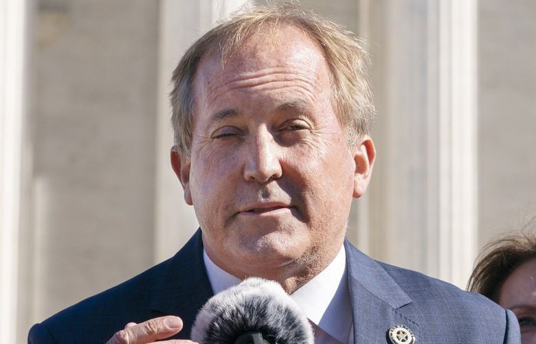 Texas Attorney General Ken Paxton, left, next to his wife and Texas State Sen. Angela Paxton, speaks to anti-abortion activists at a rally outside the Supreme Court, Monday, Nov. 1, 2021, on Capitol Hill in Washington. (AP Photo/Jacquelyn Martin)
