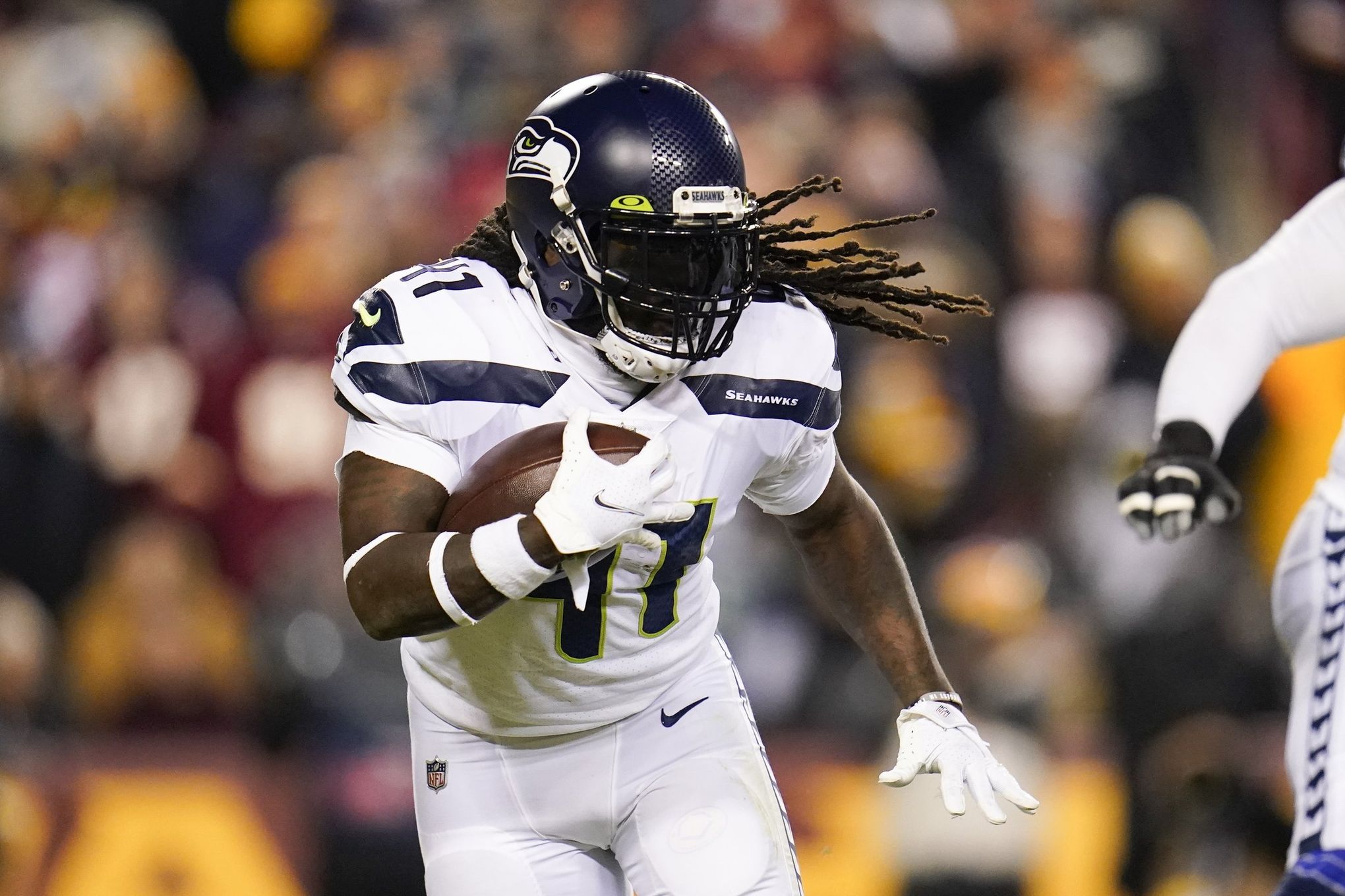 Seattle Seahawks running back Alex Collins carries the ball