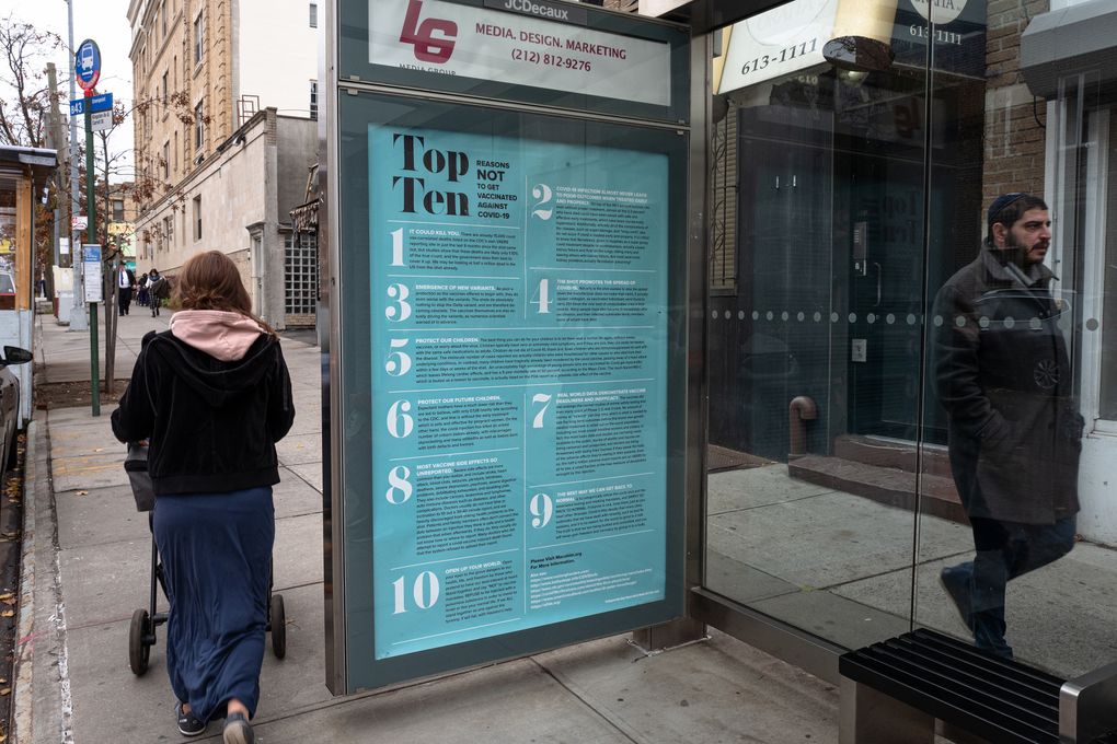 A poster arguing against getting vaccinated is seen in a bus shelter in Brooklyn, Dec. 2, 2021. City officials said the ad, which contained false information, had not been authorized — it was later removed. (Jonah Markowitz/The New York Times)