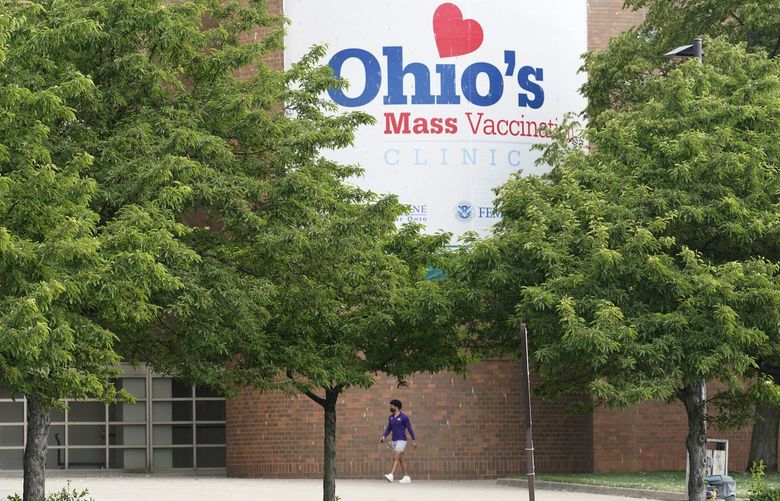 A man walk to the entrance for Ohio’s COVID-19 mass vaccination clinic at Cleveland State University, Tuesday, May 25, 2021, in Cleveland. Nearly 2.8 million residents have registered for Ohio’s Vax-a-Million vaccination incentive program, with participants hoping to win either the $1 million prize for adults or a full-ride college scholarship for children, Gov. Mike DeWine announced Monday, May 24. The winners will be announced Wednesday night at the end of the Ohio Lottery’s Cash Explosion TV show, and then each Wednesday for the next four weeks. (AP Photo/Tony Dejak)
