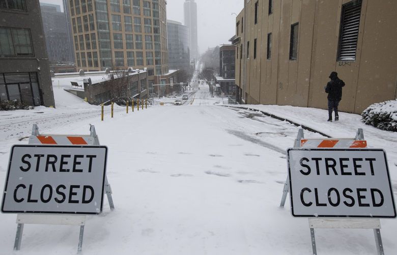 Denny Way, which borders Seattle’s South Lake union neighborhood is shut down due to snow Sunday, Dec. 26, 2021. 219190