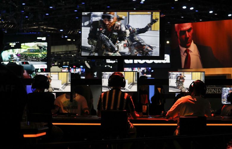 Attendees play the Activision Blizzard Inc. Call of Duty: Black Ops 4 video game during the E3 Electronic Entertainment Expo in Los Angeles, California, U.S., in Los Angeles, California, U.S., on Wednesday, June 13, 2018. For three days, leading-edge companies, groundbreaking new technologies and never-before-seen products are showcased at E3. Photographer: Patrick T. Fallon/Bloomberg